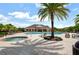 Relaxing community pool area with lounge chairs, a hot tub, a clubhouse, and lush tropical landscaping at 11109 Great Neck Rd, Riverview, FL 33578