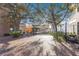 Charming brick-paved courtyard featuring benches and mature trees for a relaxing outdoor space at 11109 Great Neck Rd, Riverview, FL 33578