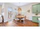 Dining area features round wooden table with a modern light fixture and access to the lanai at 11109 Great Neck Rd, Riverview, FL 33578