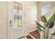 Bright entryway with a decorative front door, accent lighting, and adjacent staircase at 11109 Great Neck Rd, Riverview, FL 33578
