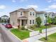 Well-manicured lawn and landscaping surround a two-story home with a white picket fence at 11109 Great Neck Rd, Riverview, FL 33578