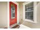 Inviting front entrance with a red door, sidelight window, and decorative wreath, number 11109 at 11109 Great Neck Rd, Riverview, FL 33578