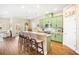 Bright kitchen features stainless appliances, island with barstool seating, and green cabinetry at 11109 Great Neck Rd, Riverview, FL 33578