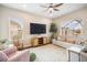 Comfortable living room features modern decor, natural lighting and ceiling fan at 11109 Great Neck Rd, Riverview, FL 33578