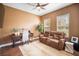 Cozy room with stylish furnishings, a ceiling fan, and two windows with views of the outside at 11109 Great Neck Rd, Riverview, FL 33578