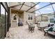 Screened in patio with outdoor seating, grill, and access to the backyard at 11109 Great Neck Rd, Riverview, FL 33578