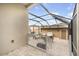 Screened patio with comfortable seating and a grill, perfect for outdoor relaxation and entertaining at 11109 Great Neck Rd, Riverview, FL 33578