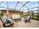 Covered patio with outdoor seating, ideal for relaxing and entertaining guests at 11109 Great Neck Rd, Riverview, FL 33578