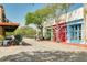 Scenic street view with colorful storefronts, outdoor seating, and lush greenery, creating a vibrant atmosphere at 11109 Great Neck Rd, Riverview, FL 33578
