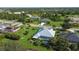 Aerial view of a community home and lush landscaping with a large screened-in pool at 1161 Rio De Janeiro Ave, Punta Gorda, FL 33983