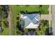 Aerial view of the home with a unique roof design and screened-in pool at 1161 Rio De Janeiro Ave, Punta Gorda, FL 33983