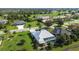 Beautiful aerial view of a home with screened pool in a golf course community at 1161 Rio De Janeiro Ave, Punta Gorda, FL 33983