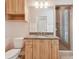 Bathroom featuring light wood vanity with granite counters and glass shower at 1161 Rio De Janeiro Ave, Punta Gorda, FL 33983