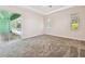 Spacious bedroom with carpet, neutral paint, and access to the outdoor pool area at 1161 Rio De Janeiro Ave, Punta Gorda, FL 33983