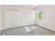 Bright bedroom with plush carpet and a window with leafy outdoor views at 1161 Rio De Janeiro Ave, Punta Gorda, FL 33983