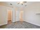 This bedroom features neutral paint and carpet, with a ceiling fan and view into the closet and hallway at 1161 Rio De Janeiro Ave, Punta Gorda, FL 33983