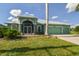 Inviting single-story home with a three-car garage, lush lawn, and charming screened entryway at 1161 Rio De Janeiro Ave, Punta Gorda, FL 33983