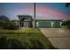 Charming single-story home with a spacious three-car garage, lush lawn, and inviting screened entryway at 1161 Rio De Janeiro Ave, Punta Gorda, FL 33983