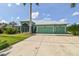 Bright, inviting single-story home with a three-car garage, set against a backdrop of blue skies and green lawn at 1161 Rio De Janeiro Ave, Punta Gorda, FL 33983