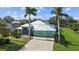 Inviting single-story home with lush landscaping and a three-car garage on a sunny day at 1161 Rio De Janeiro Ave, Punta Gorda, FL 33983