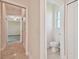 Hallway view towards a powder room and carpeted room at 1161 Rio De Janeiro Ave, Punta Gorda, FL 33983