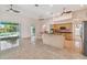 Open kitchen and living area with modern appliances, granite countertops, and backyard pool views at 1161 Rio De Janeiro Ave, Punta Gorda, FL 33983
