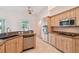 Bright kitchen features stainless appliances, granite counters, tile floors, and light wood cabinets at 1161 Rio De Janeiro Ave, Punta Gorda, FL 33983