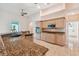 Kitchen with granite counters, stainless appliances, tile floors, and light wood cabinets at 1161 Rio De Janeiro Ave, Punta Gorda, FL 33983