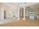 Expansive living area boasting tile floors, elegant columns, and a view of the backyard pool at 1161 Rio De Janeiro Ave, Punta Gorda, FL 33983