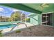 This outdoor patio has a pool and hot tub, a ceiling fan, and views of the lawn at 1161 Rio De Janeiro Ave, Punta Gorda, FL 33983