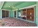The outdoor patio has a ceiling fan, brick pavers and a view into the living room through sliding glass doors at 1161 Rio De Janeiro Ave, Punta Gorda, FL 33983