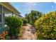 A brick path leads to the house, lined with lush landscaping at 1161 Rio De Janeiro Ave, Punta Gorda, FL 33983