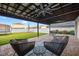 Relaxing backyard featuring a covered patio, seating area, and green lawn at 13110 Shumard Way, Riverview, FL 33579