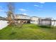Large backyard with green grass, a covered patio, and a trampoline at 13110 Shumard Way, Riverview, FL 33579