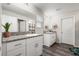 Bright bathroom featuring dual vanities with granite countertops and wood-look floors at 13110 Shumard Way, Riverview, FL 33579