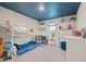 Whimsical bedroom featuring a bunk bed, desk, and blue ceiling with stars at 13110 Shumard Way, Riverview, FL 33579
