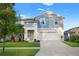 Charming two-story home featuring a well-manicured lawn and attached two-car garage at 13110 Shumard Way, Riverview, FL 33579