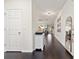 Inviting hallway with hardwood floors, shiplap accent wall, and neutral paint provides a warm welcome at 13110 Shumard Way, Riverview, FL 33579