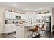 Bright kitchen with white cabinetry, granite countertops, and stainless steel appliances at 13110 Shumard Way, Riverview, FL 33579