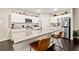 Open kitchen with stainless steel appliances, center island, and bright white cabinets for a modern look at 13110 Shumard Way, Riverview, FL 33579