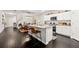 Modern kitchen with granite countertops, stainless steel appliances, and an island with barstool seating at 13110 Shumard Way, Riverview, FL 33579
