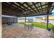 Covered brick patio with ceiling fans, outdoor seating, and views of the backyard at 13110 Shumard Way, Riverview, FL 33579