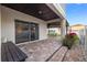 Covered patio featuring brick pavers, a dark wood bench, and sliding glass doors at 13110 Shumard Way, Riverview, FL 33579