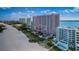 Aerial shot of a multi-story complex by the bay with beach access at 1350 Gulf Blvd # 502, Clearwater Beach, FL 33767