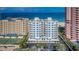 Stunning aerial view of the beachfront condo building with ocean views and lush landscaping at 1350 Gulf Blvd # 502, Clearwater Beach, FL 33767