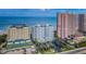 Aerial view of the Utopia condo community, showcasing its pool, tennis courts, and beachfront location at 1350 Gulf Blvd # 502, Clearwater Beach, FL 33767