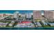 Stunning aerial view featuring beachfront condos, clear ocean waters, and nearby residential areas at 1350 Gulf Blvd # 502, Clearwater Beach, FL 33767
