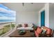 Cozy balcony seating area with a comfortable couch and chairs offering stunning ocean views at 1350 Gulf Blvd # 502, Clearwater Beach, FL 33767