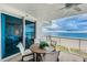 Relaxing balcony view with a table and seating overlooking a picturesque ocean view at 1350 Gulf Blvd # 502, Clearwater Beach, FL 33767
