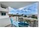 Charming balcony with blue chairs and picturesque views of the beach, ocean, and blue skies at 1350 Gulf Blvd # 502, Clearwater Beach, FL 33767